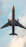gray and yellow airplane under white clouds during daytime
