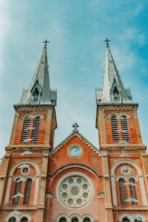 brown and gray concrete church under cloudy sky during daytime