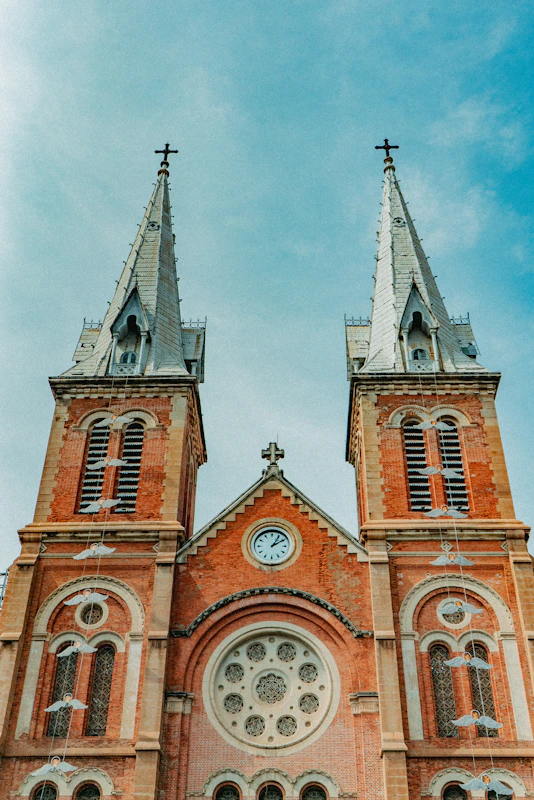 brown and gray concrete church under cloudy sky during daytime