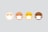 Four stylized emoji faces lined up horizontally, each wearing a white mask. The faces have different skin tones ranging from light beige to dark brown. All faces have simple, closed eyes and are set against a plain pale background.