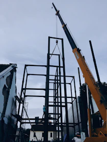 yellow and black crane near building