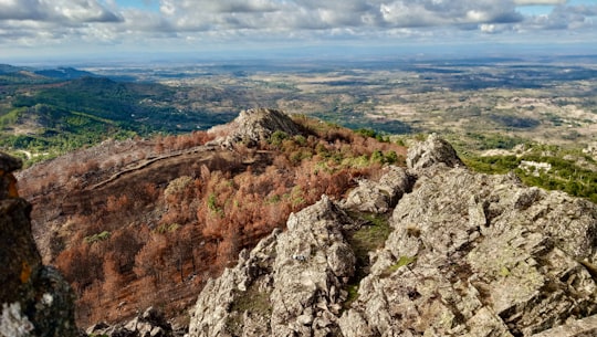 gray rocky mountain under blue sky during daytime in Serra de São Mamede Natural Park Portugal