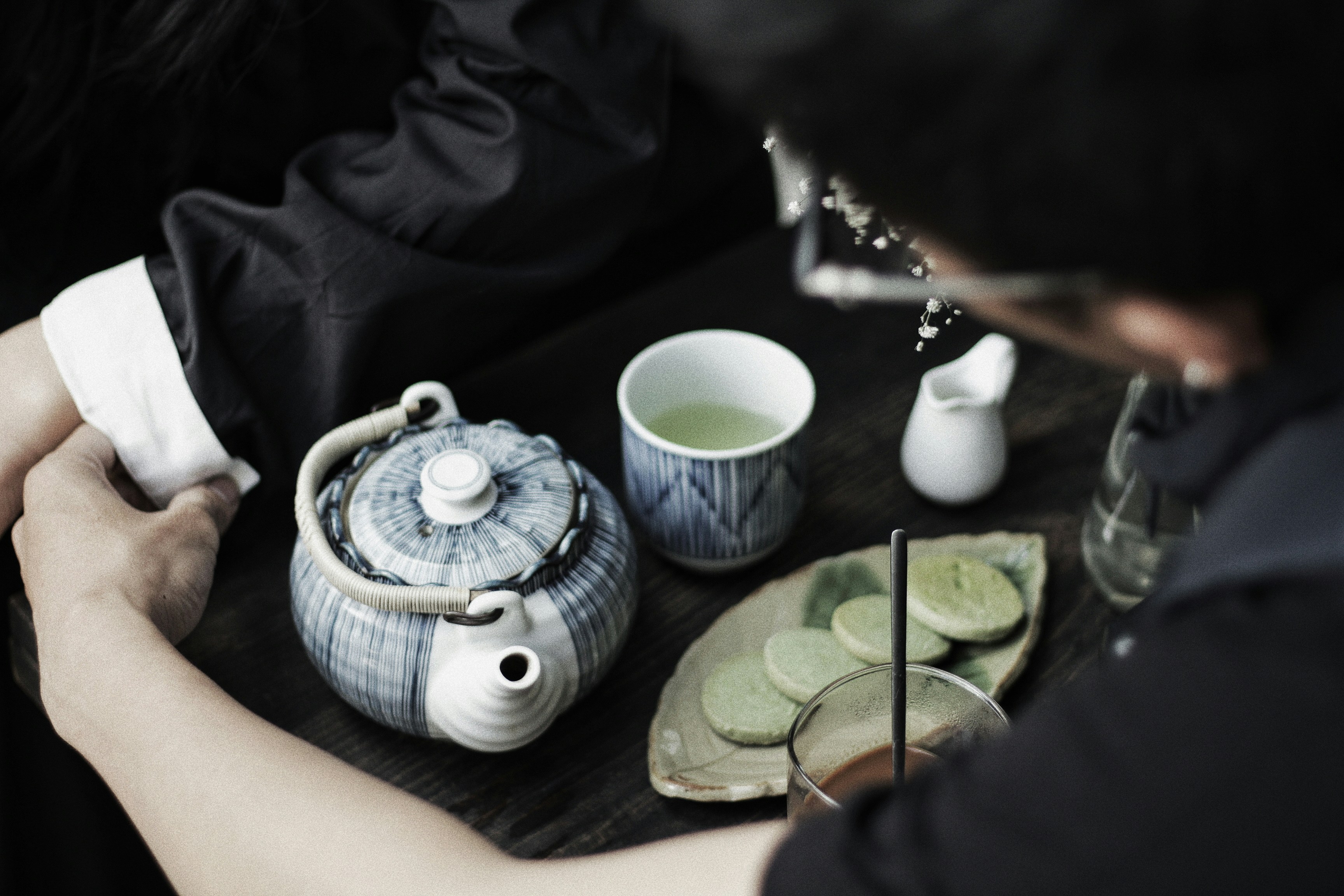 blue and white ceramic teapot on green and white ceramic saucer