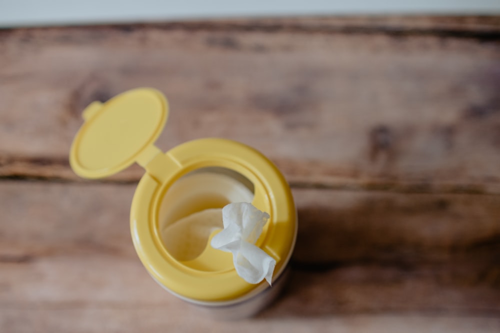 a yellow container with a tissue paper in it