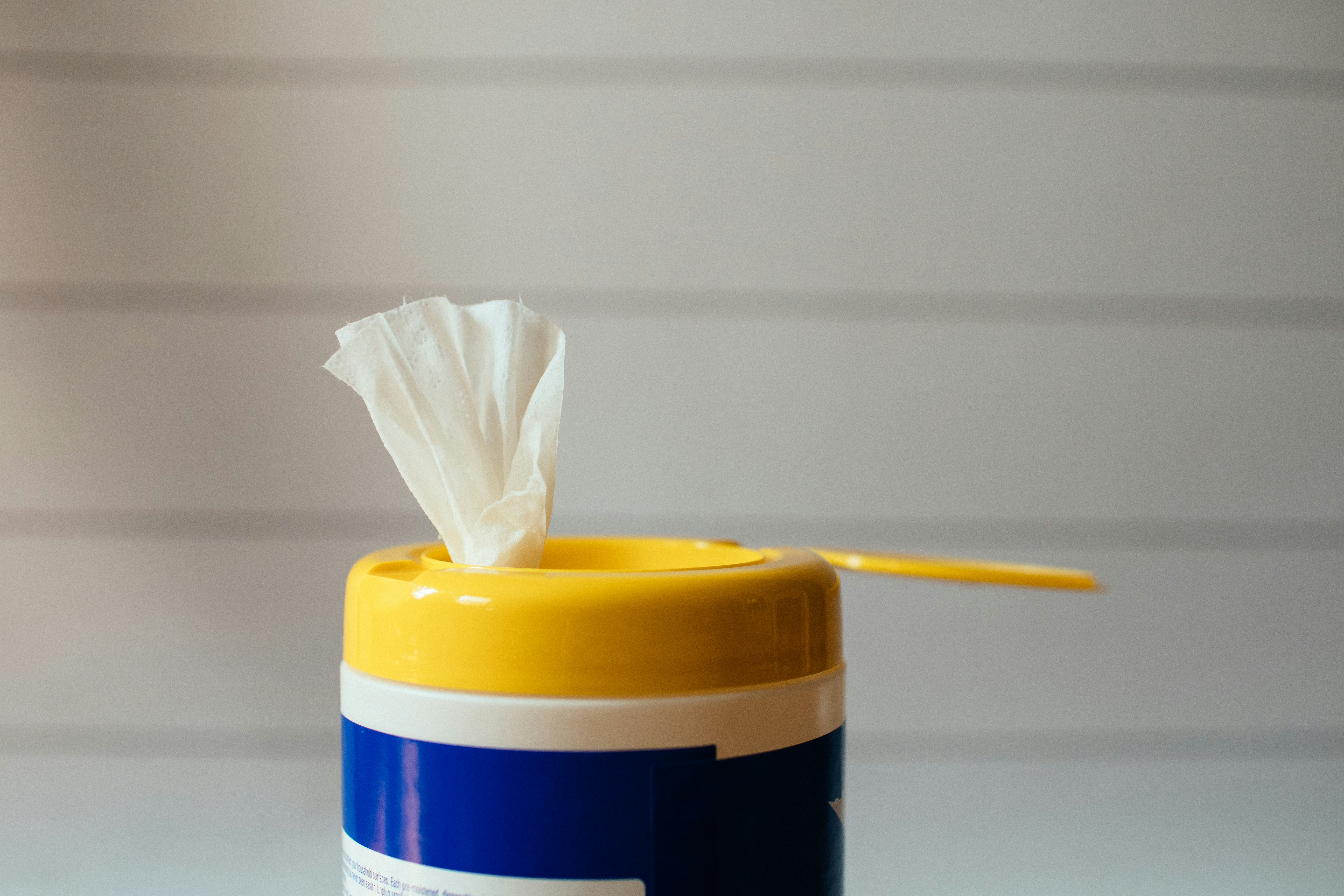 yellow pencil on white and blue plastic container