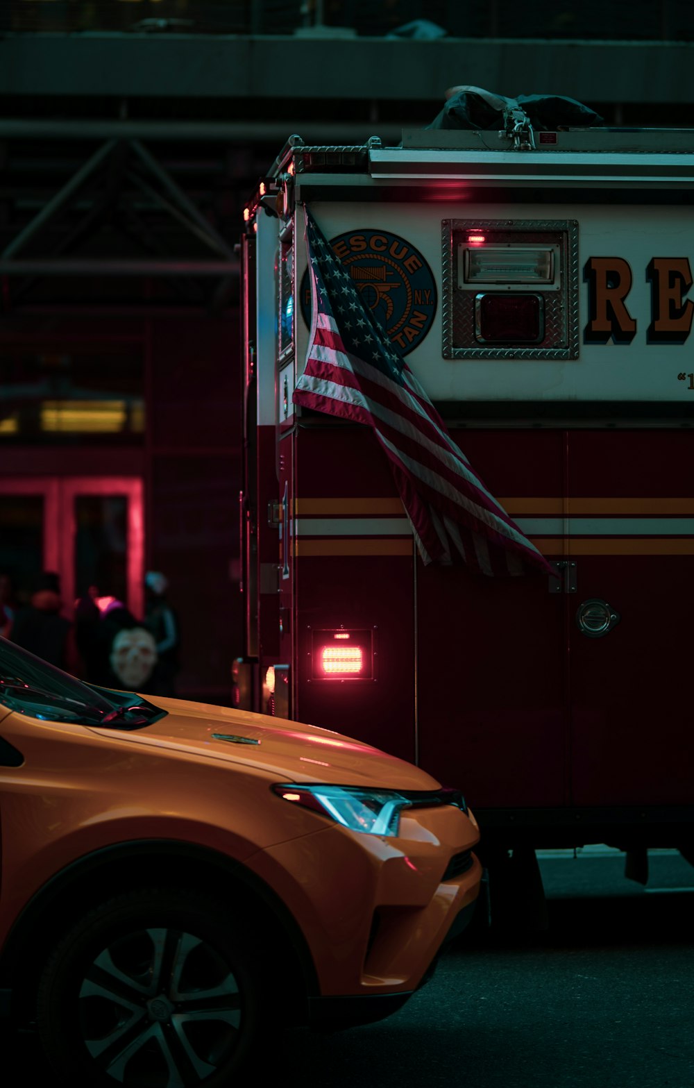 orange car in front of red and white store