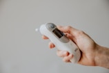 Close-up of a hand holding a digital thermometer, highlighting precision