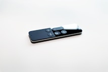 black remote control on white surface
