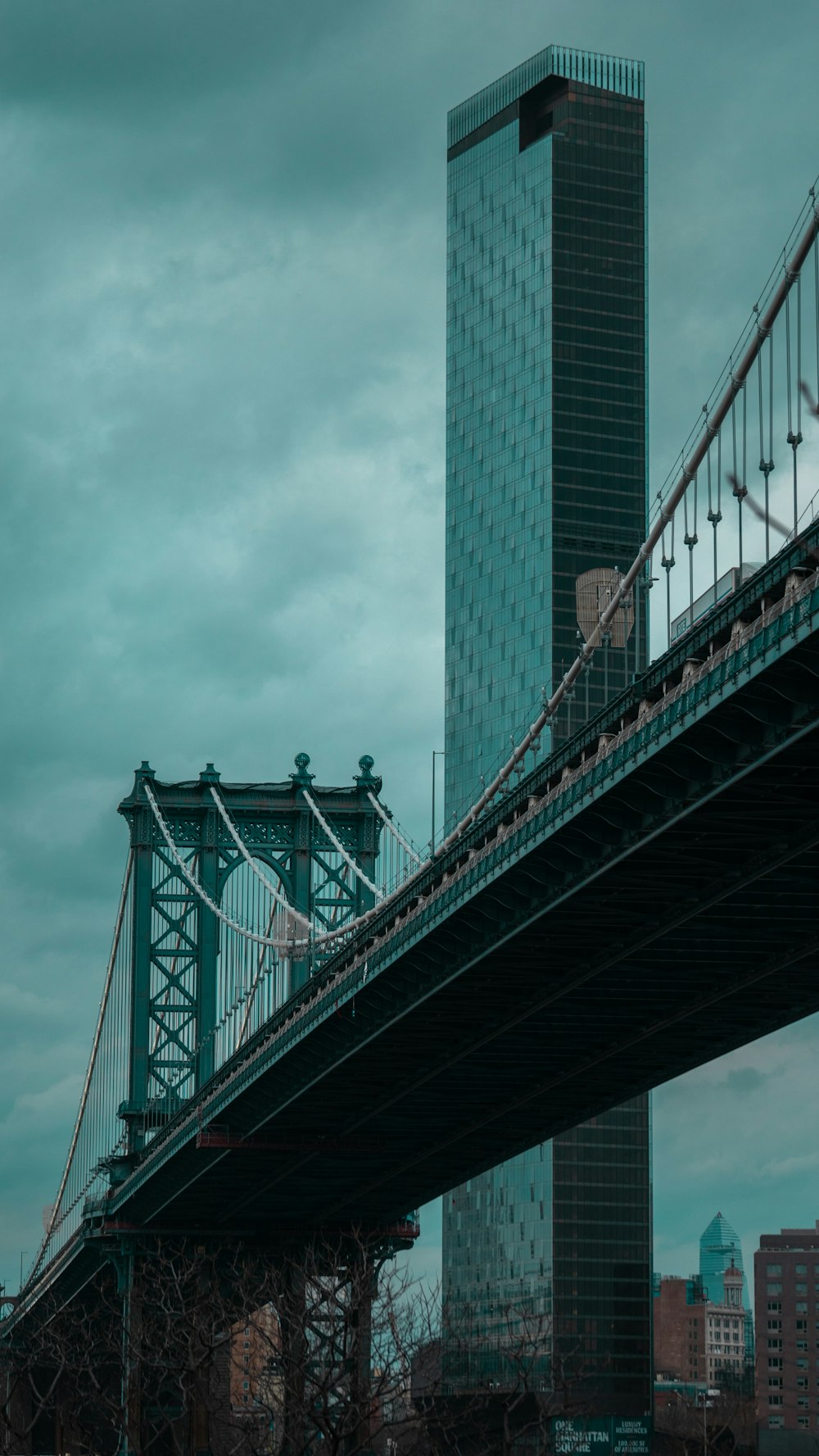 green bridge under cloudy sky during daytime