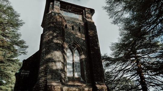 brown brick building under blue sky during daytime in St. John in the Wilderness India