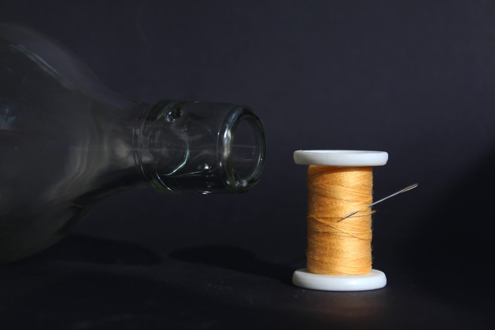 brown thread on white plastic spool