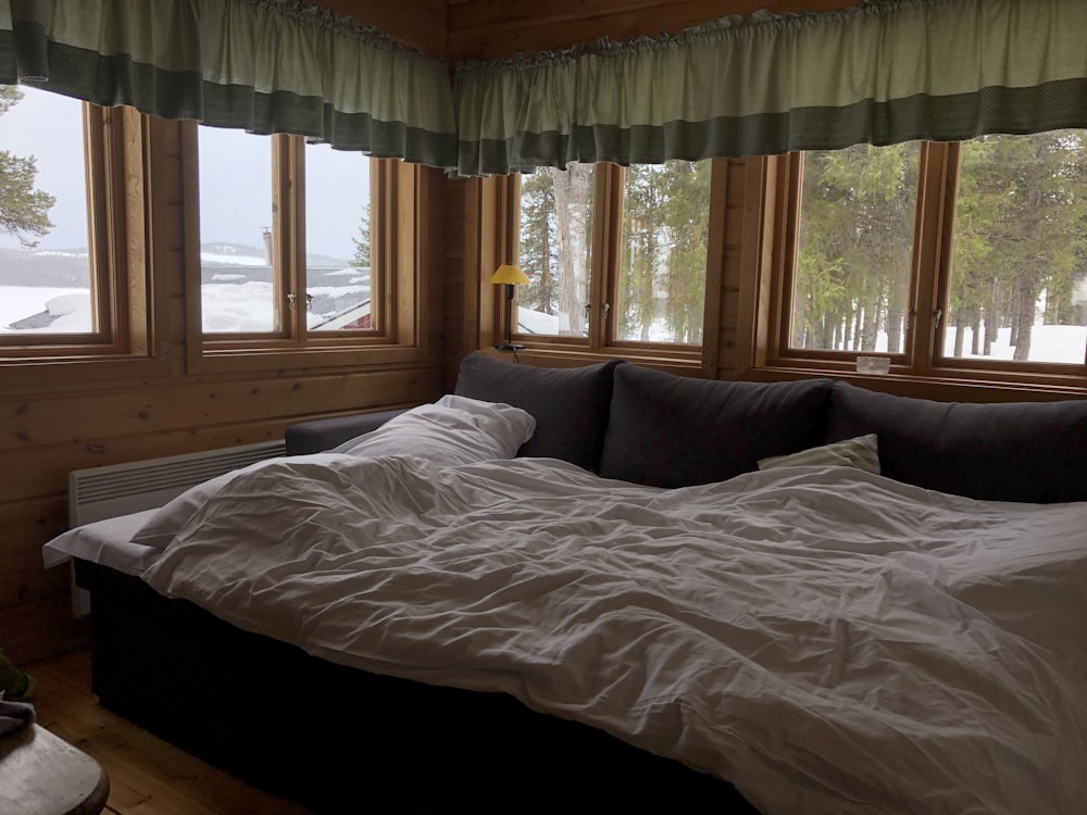 white bed linen near window