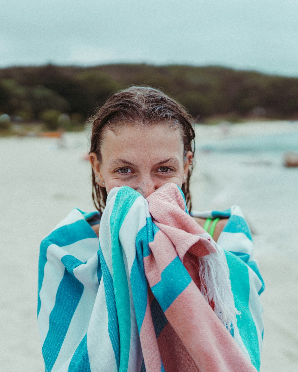 woman covering her body with white and blue blanket