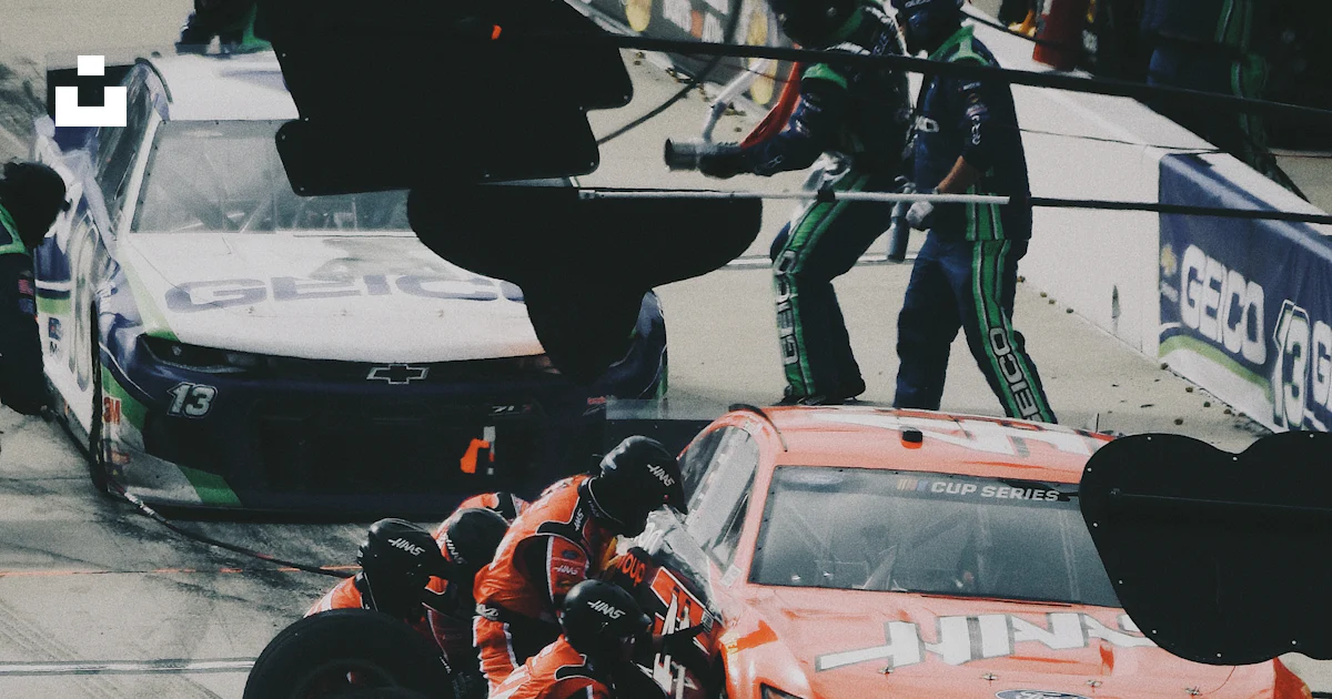 Black Man Racing Man in black jacket and pants riding orange and black racing car photo ...