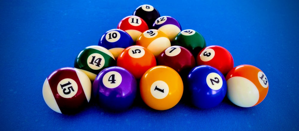 billiard balls on blue billiard table