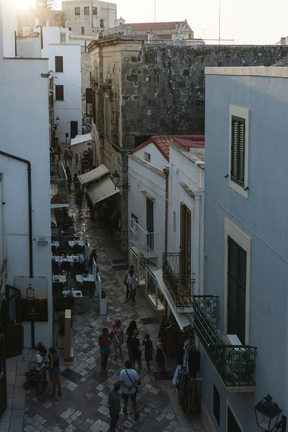 people walking on sidewalk near building during daytime