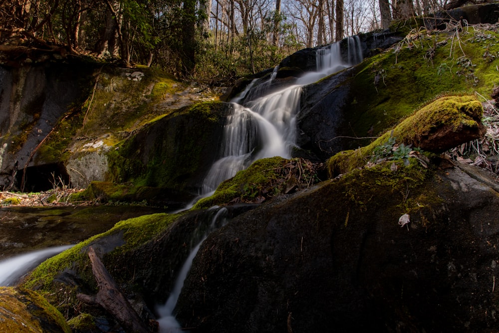 water falls on brown rocky mountain