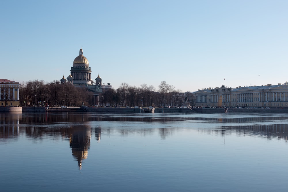 brown and white dome building near body of water during daytime