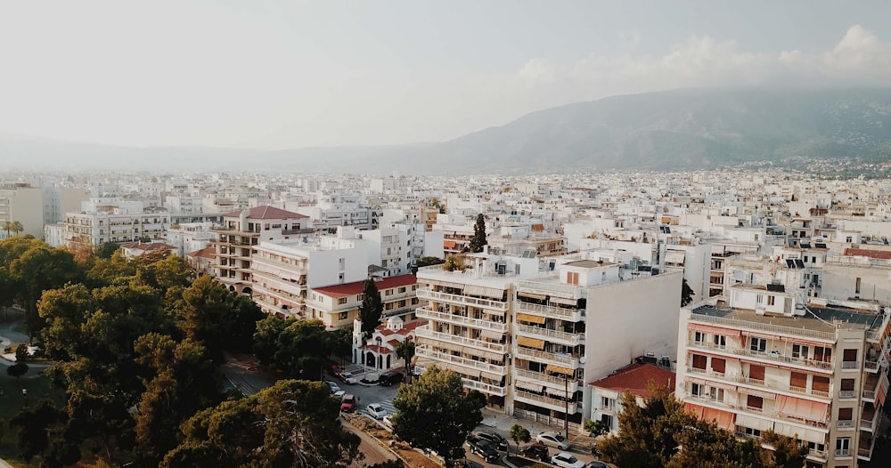 white and brown concrete buildings near mountain during daytime