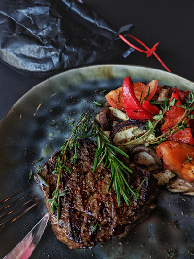 A rustic plated meat dish, evocative of wild game and nose-to-tail cooking