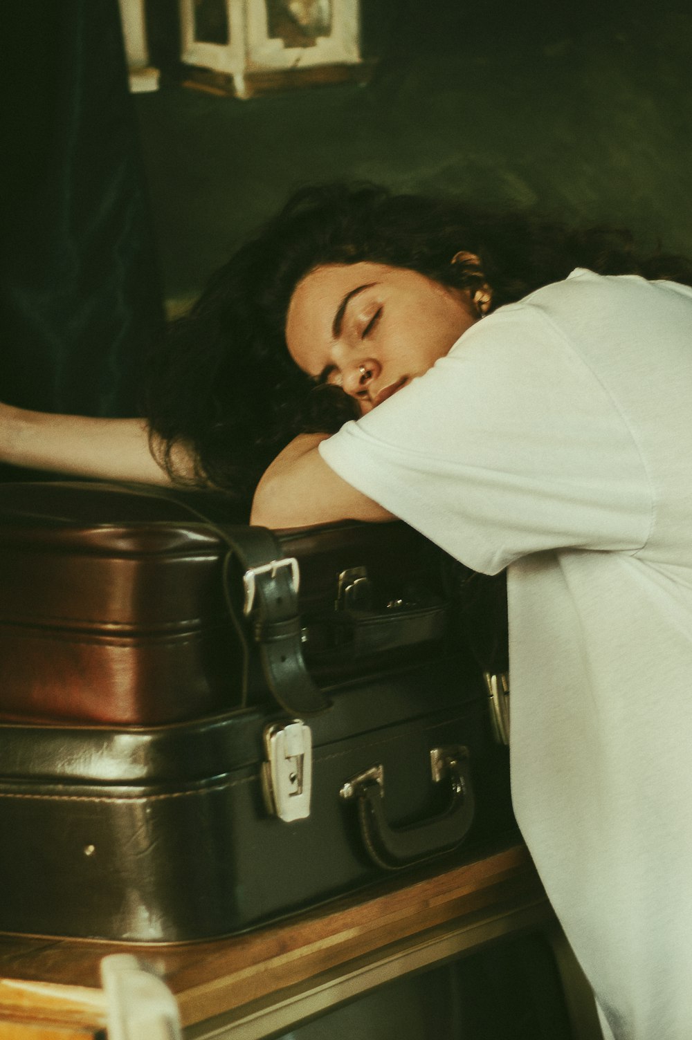 woman in white shirt lying on black leather sofa