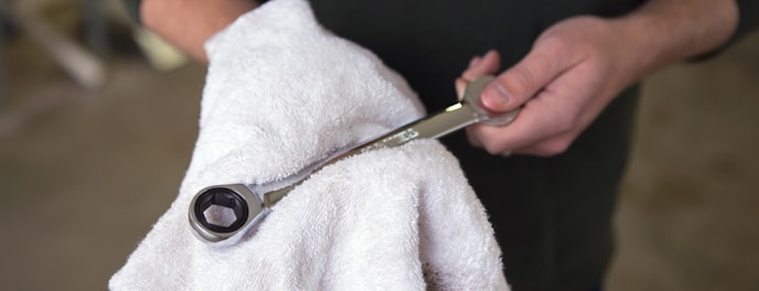 person holding silver and black scissors