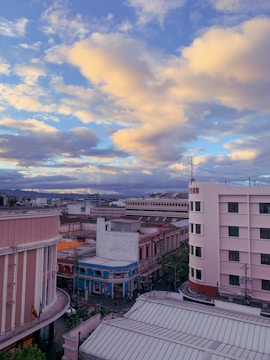 A cinematic shot of a cityscape at dusk with warm lighting.