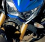 Close-up of a motorcycle accessory with bright blue and white colors.