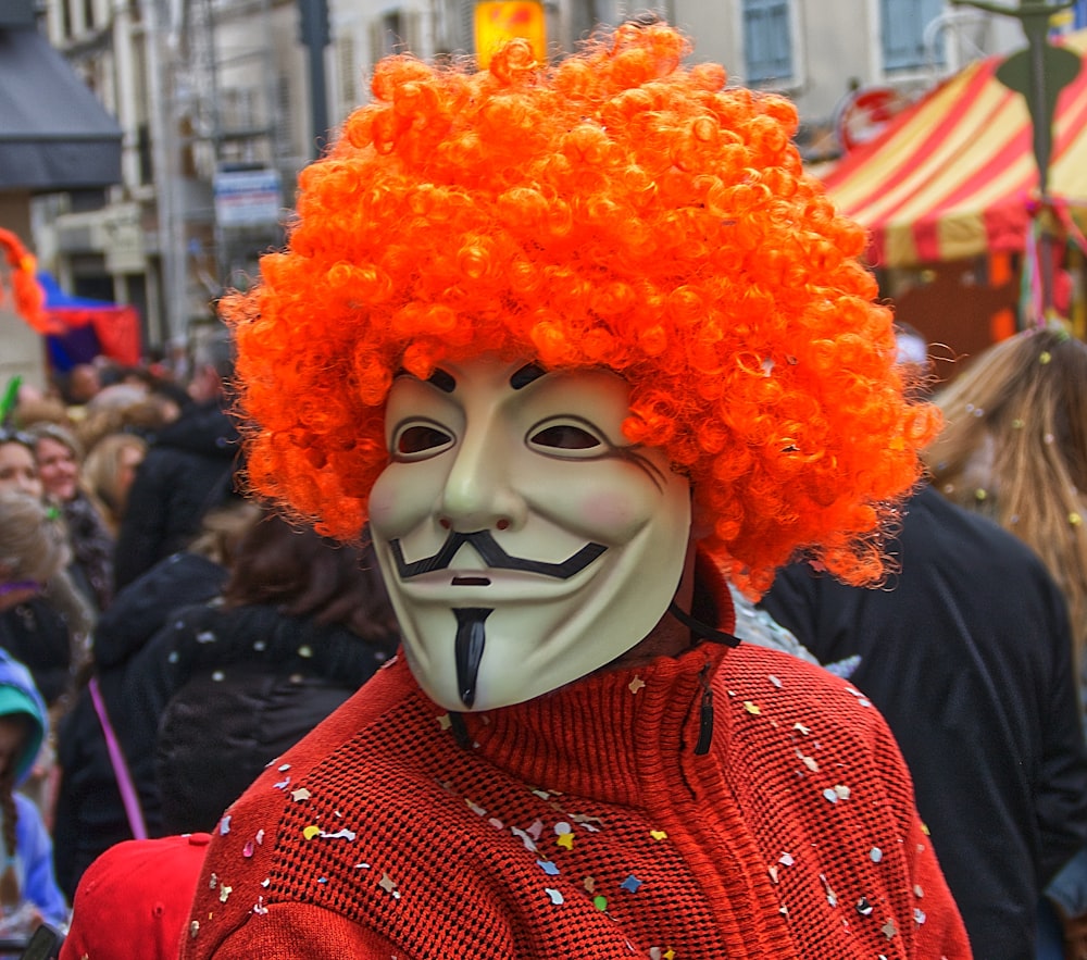 person in red knit sweater wearing mask