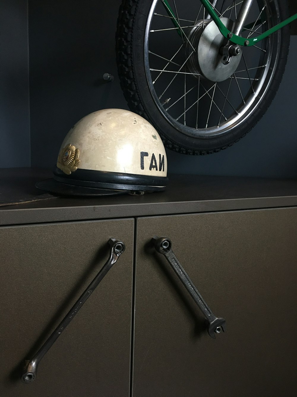 white and black helmet on gray cabinet