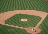 people playing baseball on field during daytime