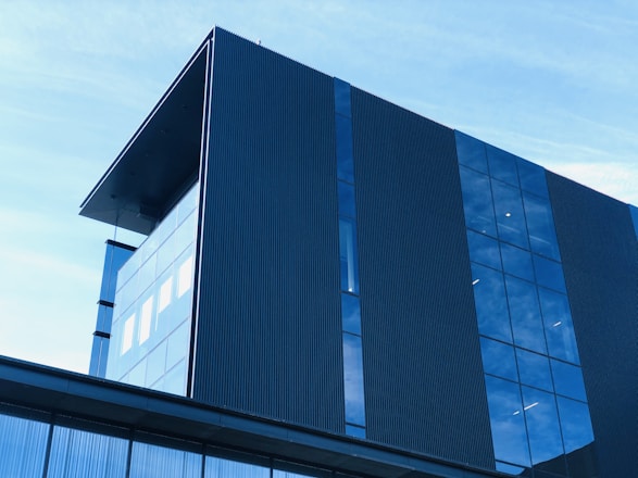 A modern commercial building with glass windows reflecting the Maryland skyline.