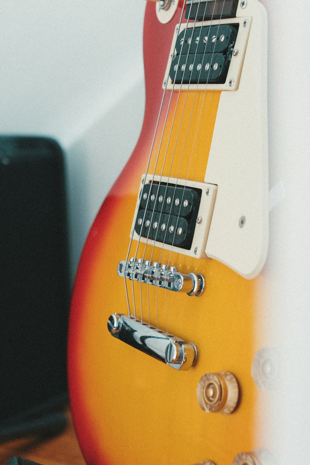 orange and white electric guitar