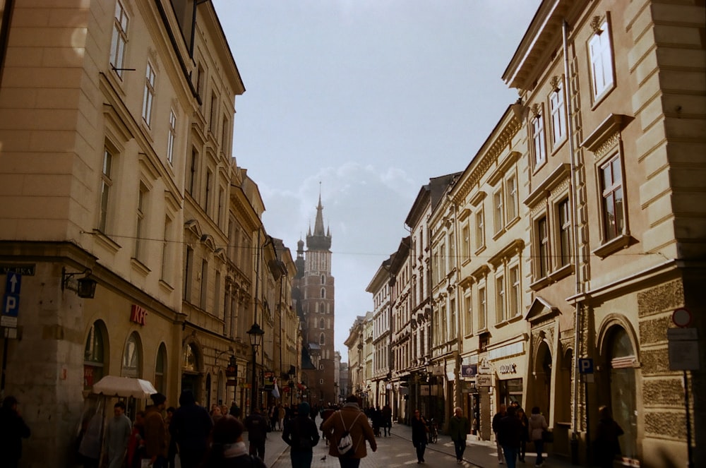 people walking on street between buildings during daytime