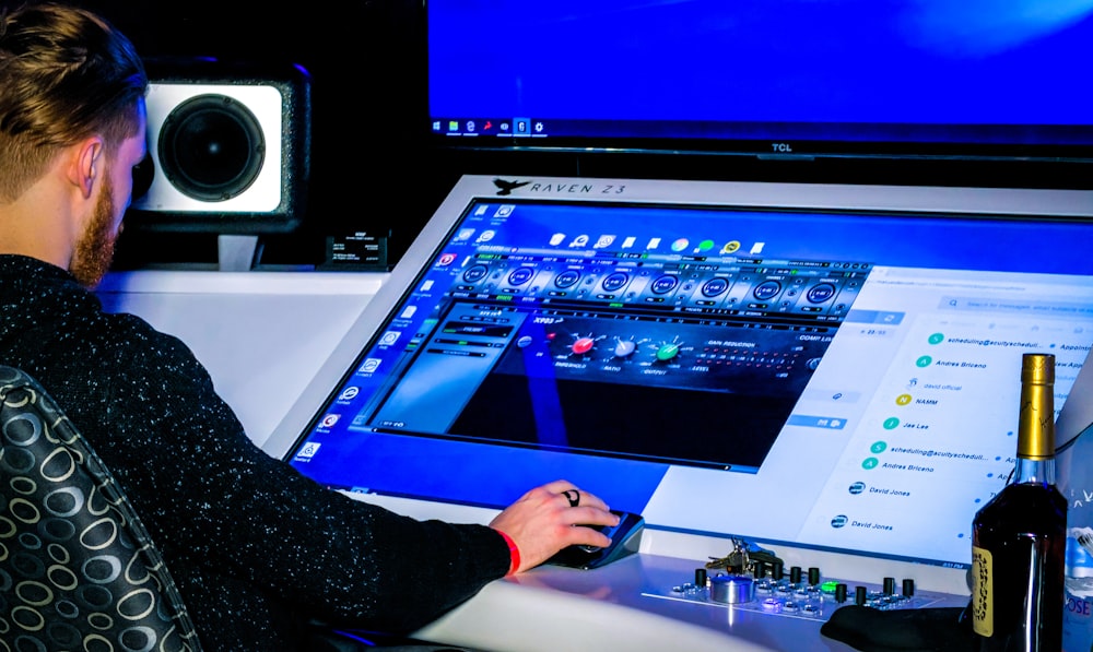 person in black long sleeve shirt playing game on computer