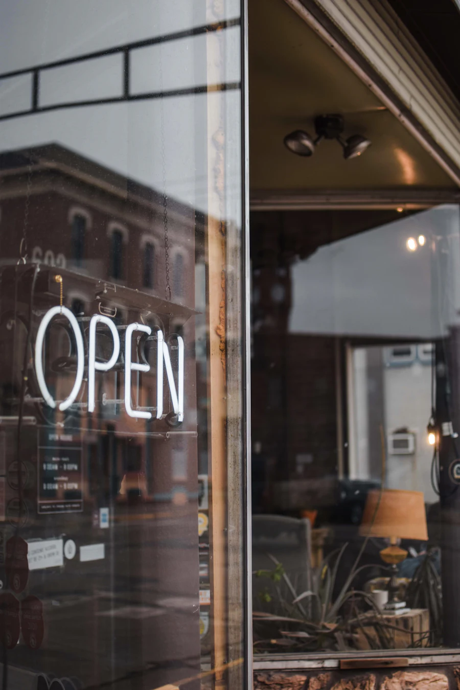 Open sign hanging on a Denver small business storefront door