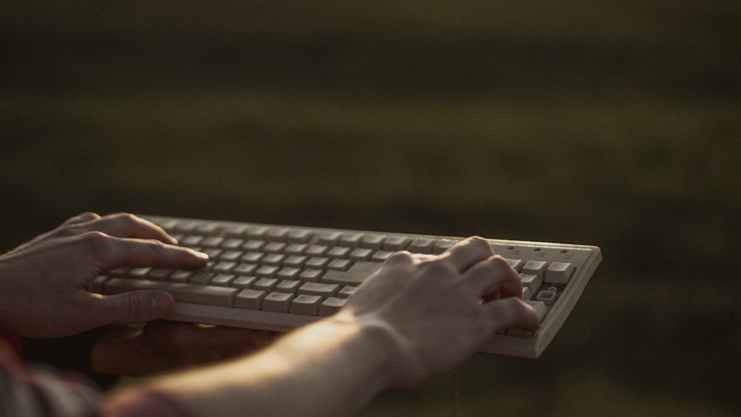 person using black and gray computer keyboard,