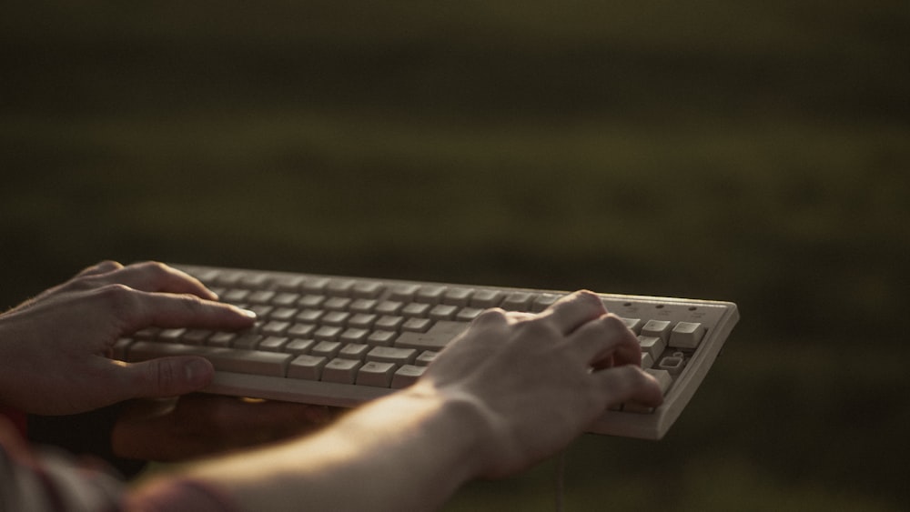 person using black and gray computer keyboard