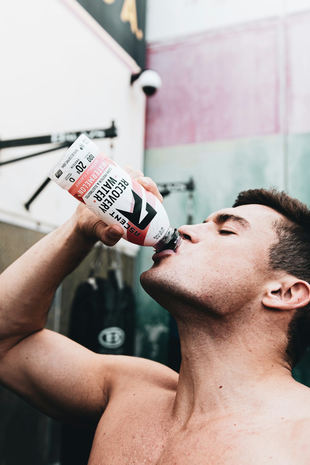 man drinking coca cola bottle