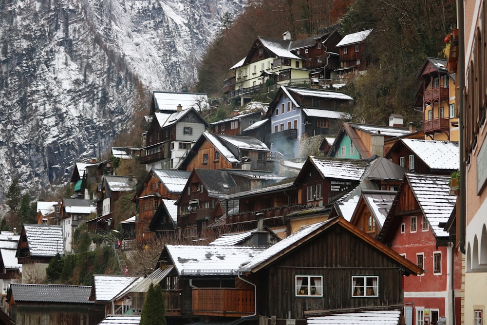 brown and white houses near mountain during daytime