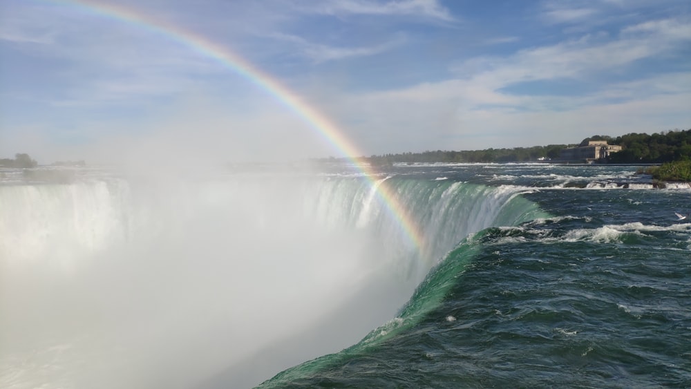 rainbow over green and gray mountain