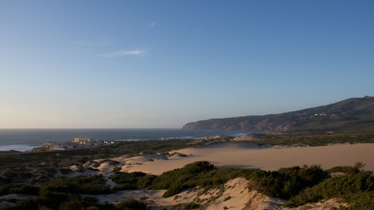 aerial view of a city near the sea during daytime in Guincho Beach Portugal