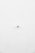 A minimalist image featuring a single security camera mounted on a stark white wall. The camera is positioned slightly off-center towards the bottom of the frame, with its small, round shape creating a subtle focal point against the expansive white background.