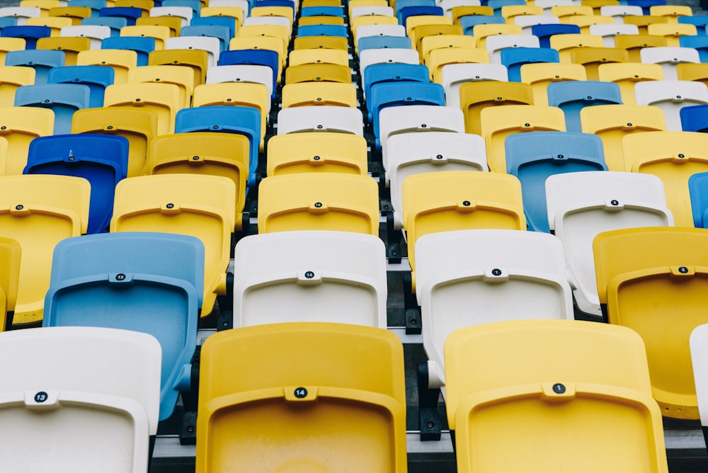 rows of yellow and blue seats in a stadium