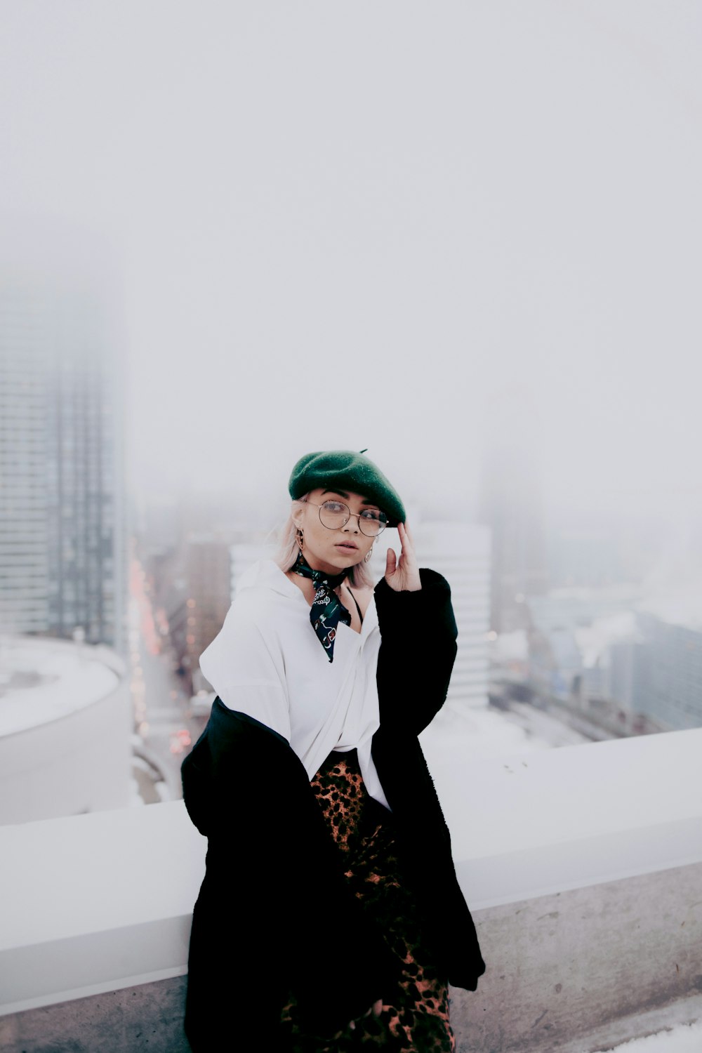 woman in green knit cap and black coat
