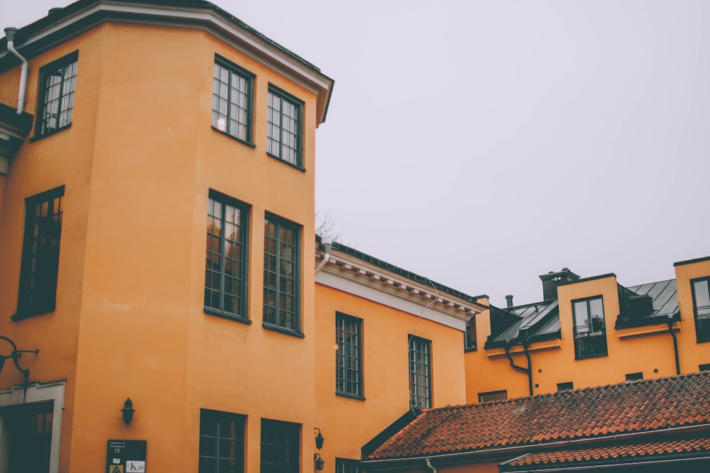 yellow concrete building under white sky during daytime