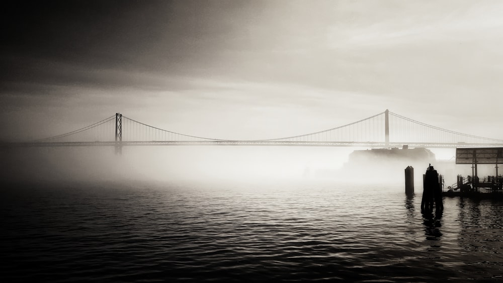 a foggy day with a bridge in the background