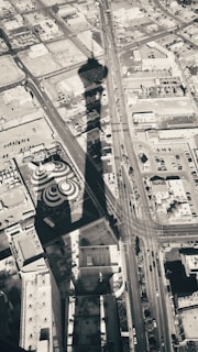 Aerial perspective of a tower casting a long shadow over the landscape.