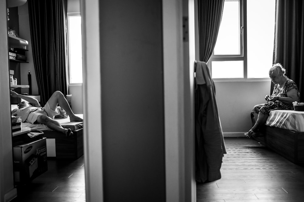 gray scale photo of woman sitting on chair