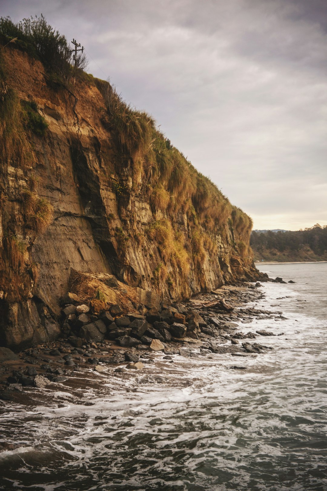 brown rock formation beside sea during daytime